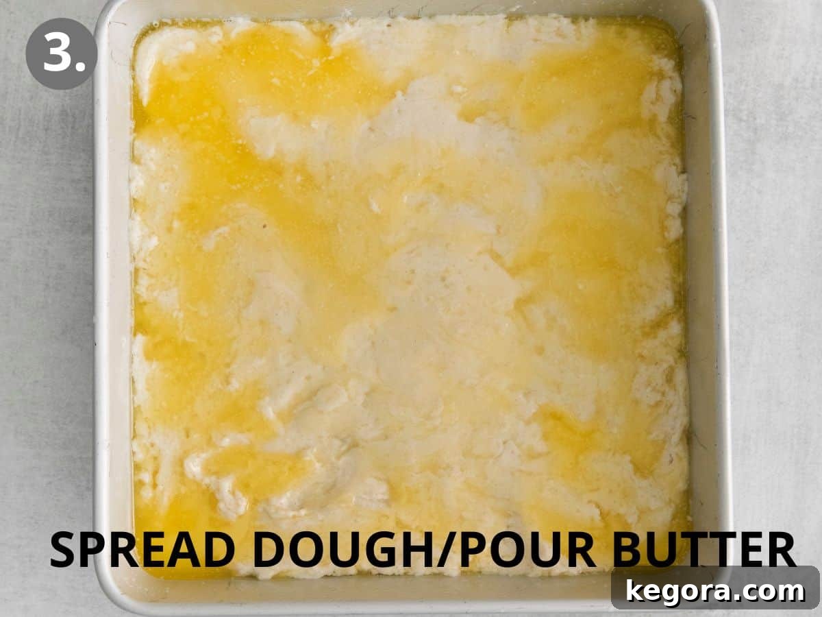 Butter-Dipped Gluten-Free Biscuits 6 Gluten-free biscuit dough spread evenly in a baking pan with melted butter generously poured over the top.