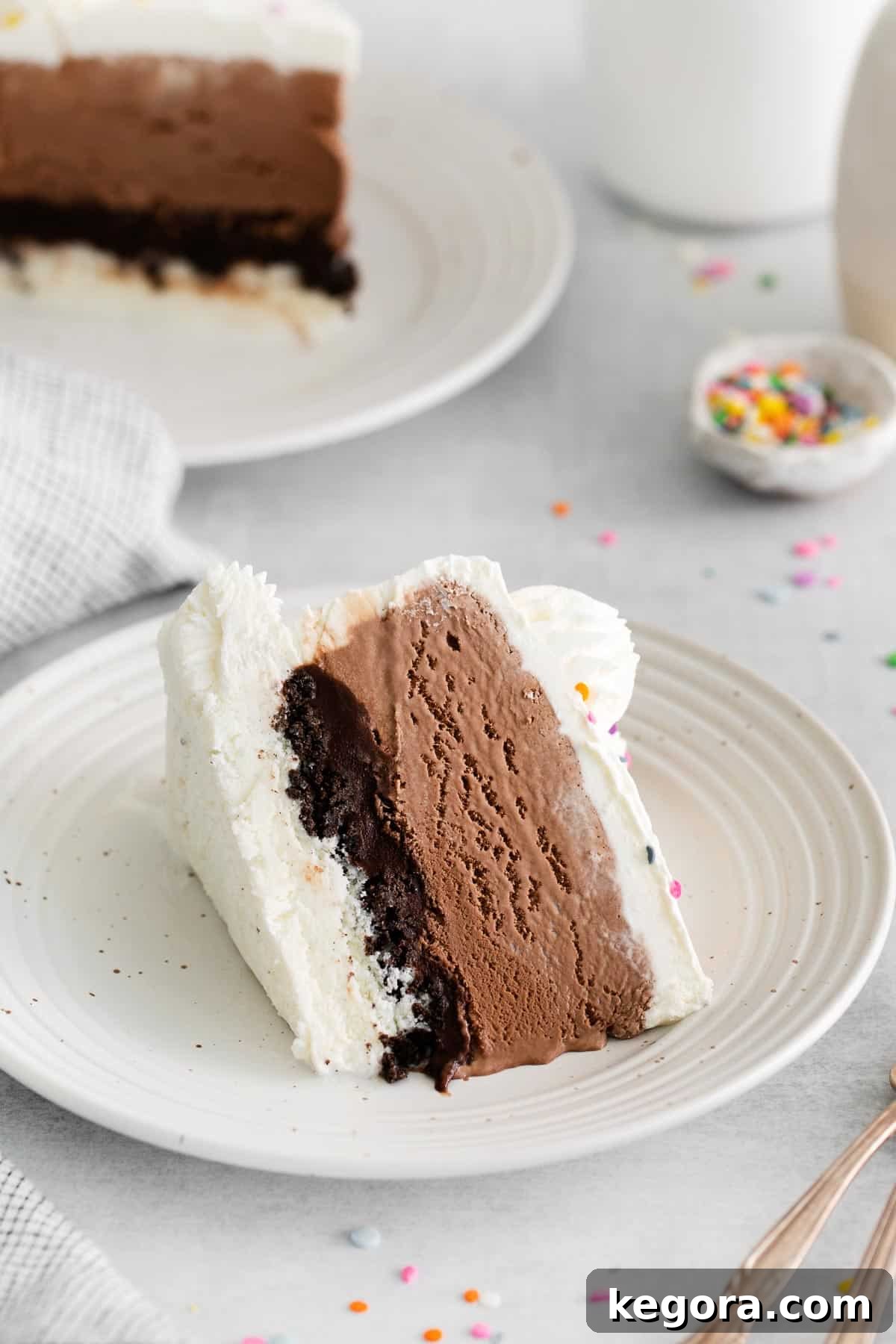 A perfectly portioned slice of gluten-free ice cream cake resting on a plate, showcasing its beautiful layers.