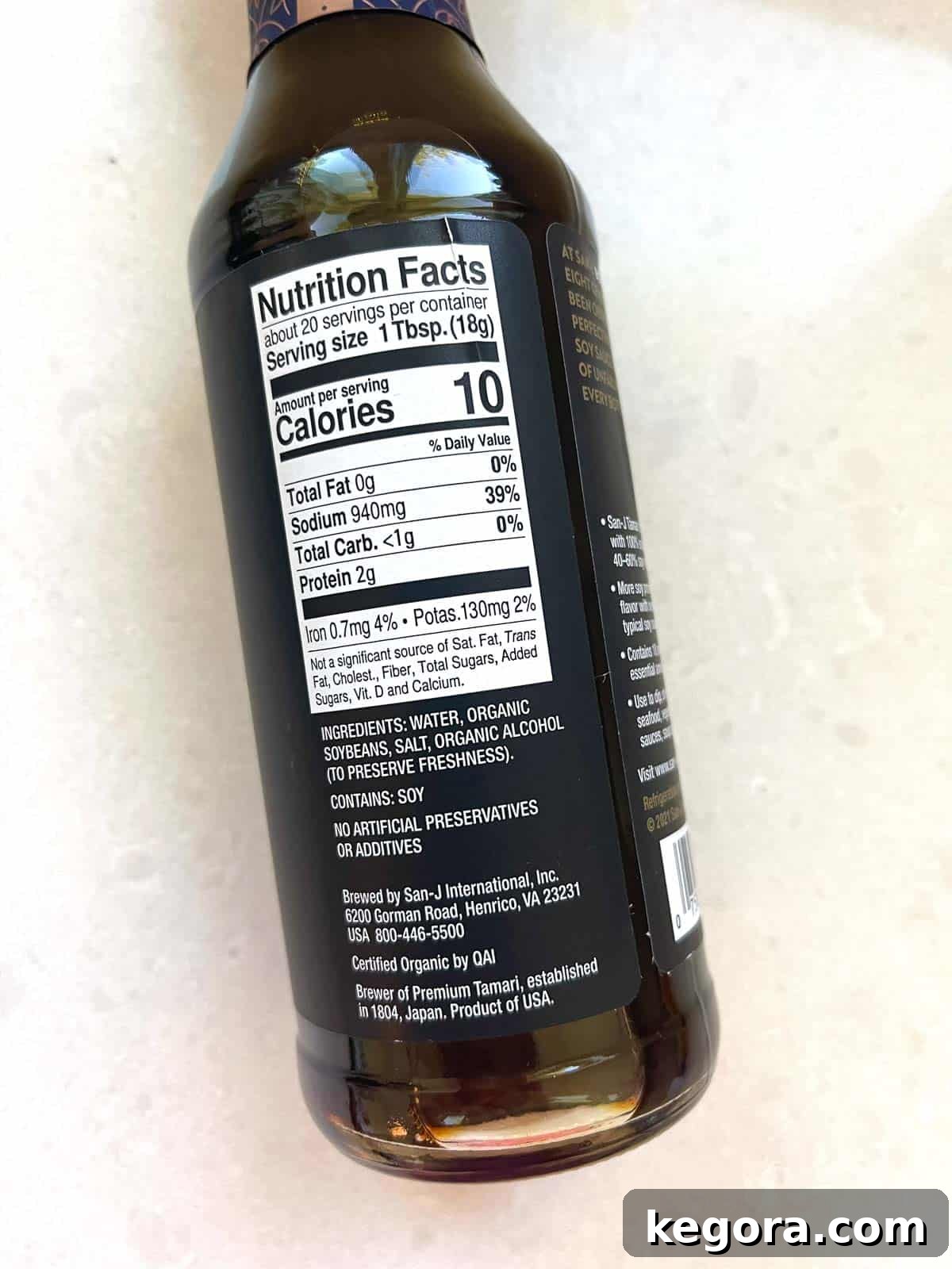 A bottle of soy sauce clearly labeled 'Gluten-Free' on a white kitchen counter, emphasizing safe choices.