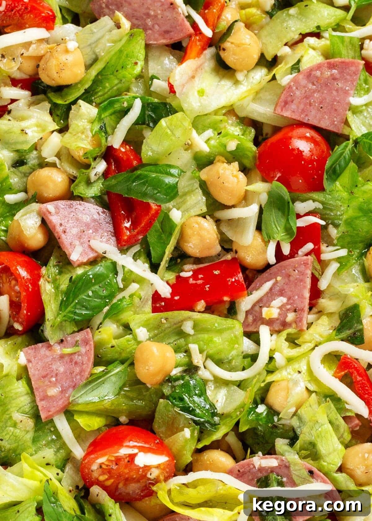 Zesty Italian Chopped Salad 3 Close-up view of the Italian Chopped Salad, highlighting the freshness of basil, vibrant tomatoes, and savory salami pieces.