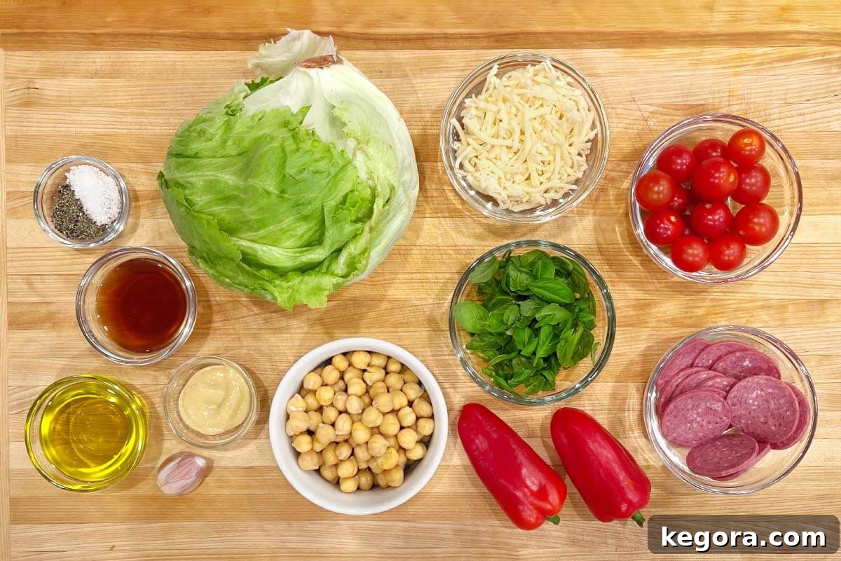 Zesty Italian Chopped Salad 4 Assorted fresh ingredients for Italian Chopped Salad dressing and salad laid out on a rustic wooden board, ready for preparation.
