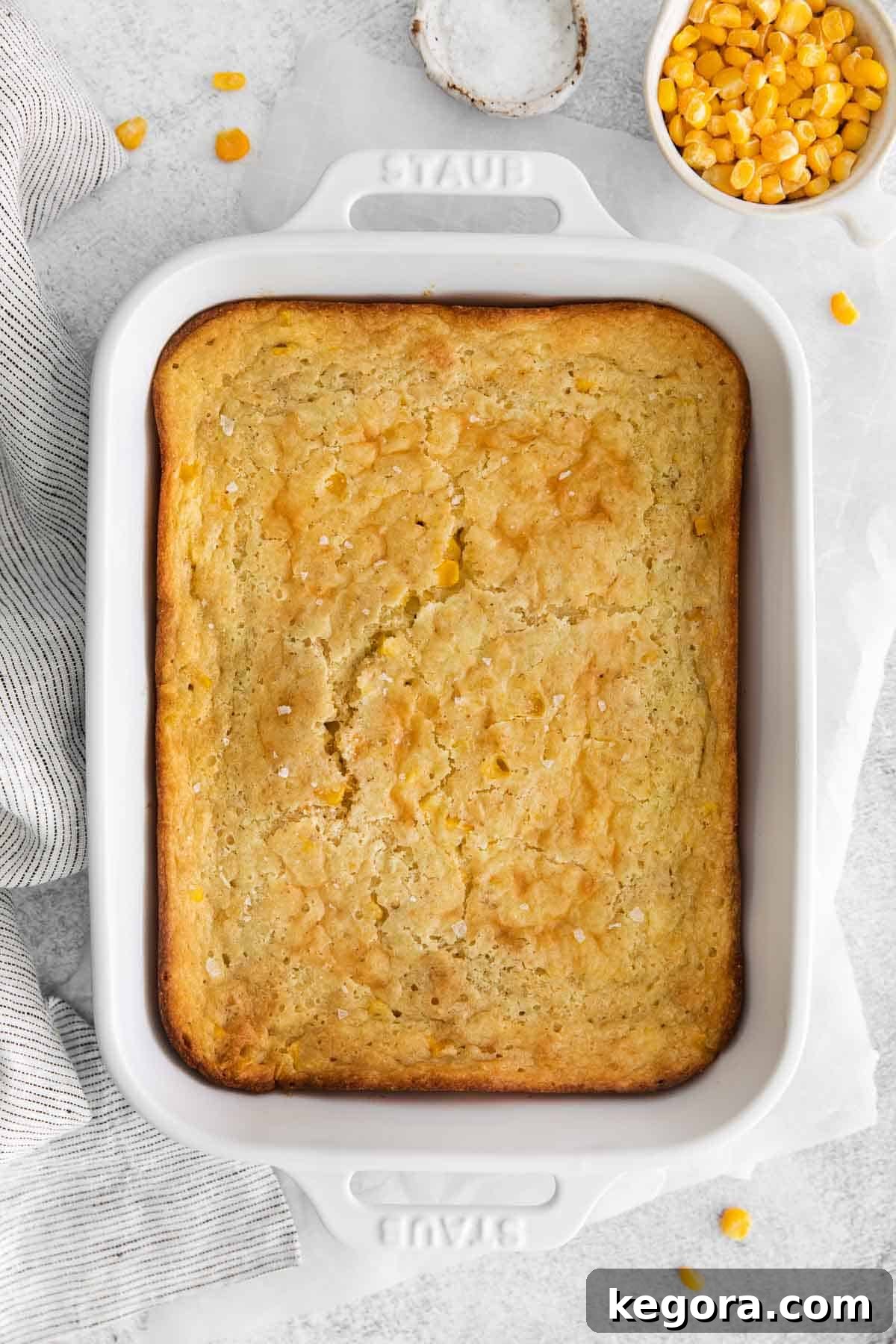 Creamy Gluten-Free Corn Bake 2 An inviting overhead view of a golden brown, bubbling gluten-free corn casserole in a baking dish, freshly baked and ready to serve