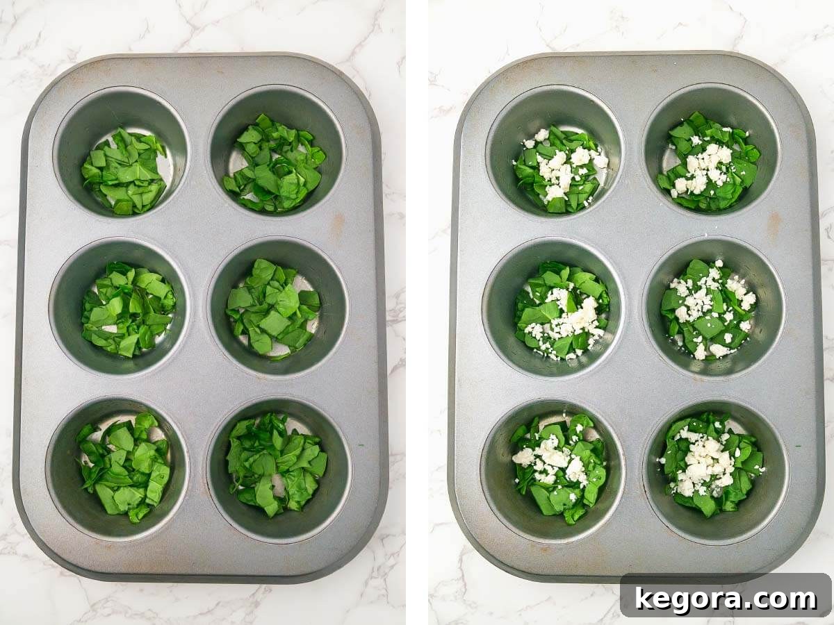 6 hole muffin tin with chopped spinach in the holes, feta cheese added.
