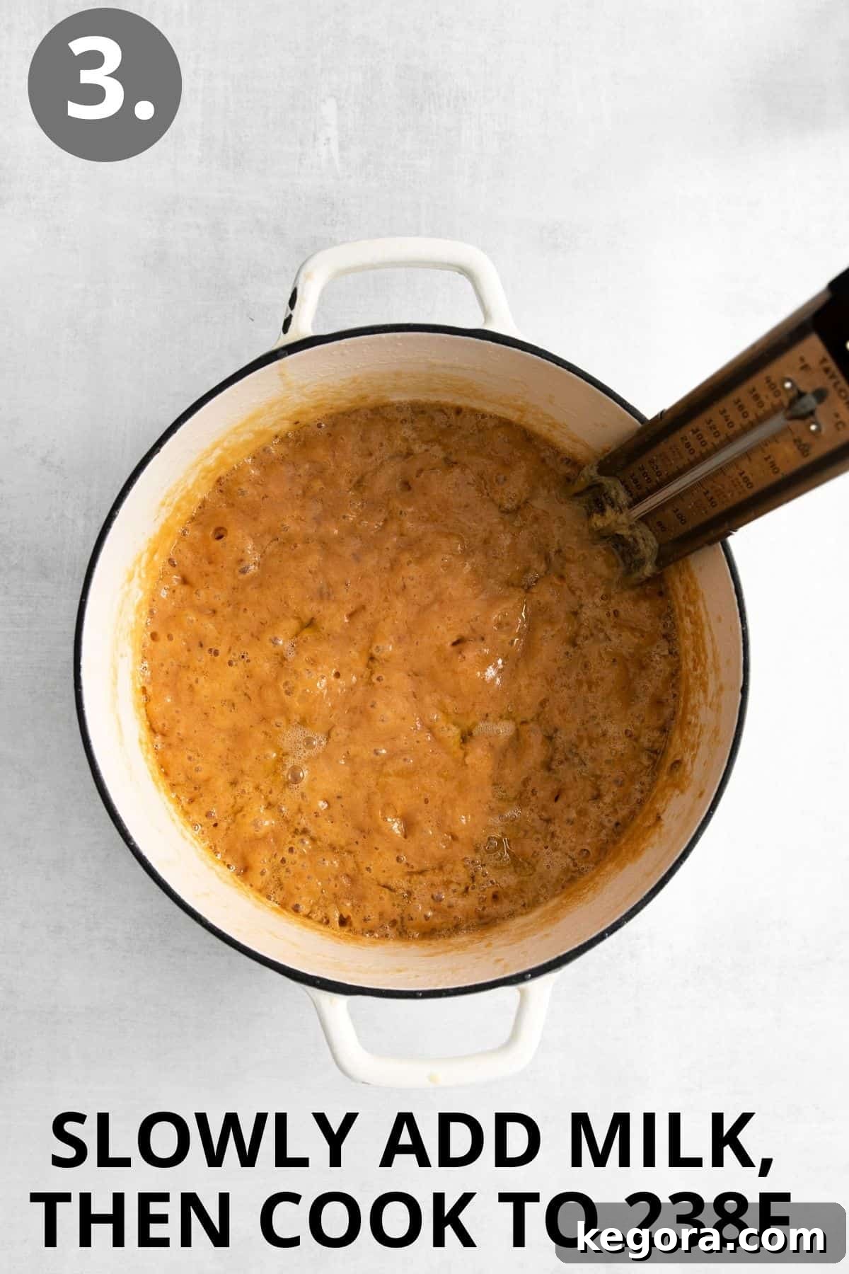 Butter, sugar, and milk combined in a pot and turning golden brown, with a thermometer on the side
