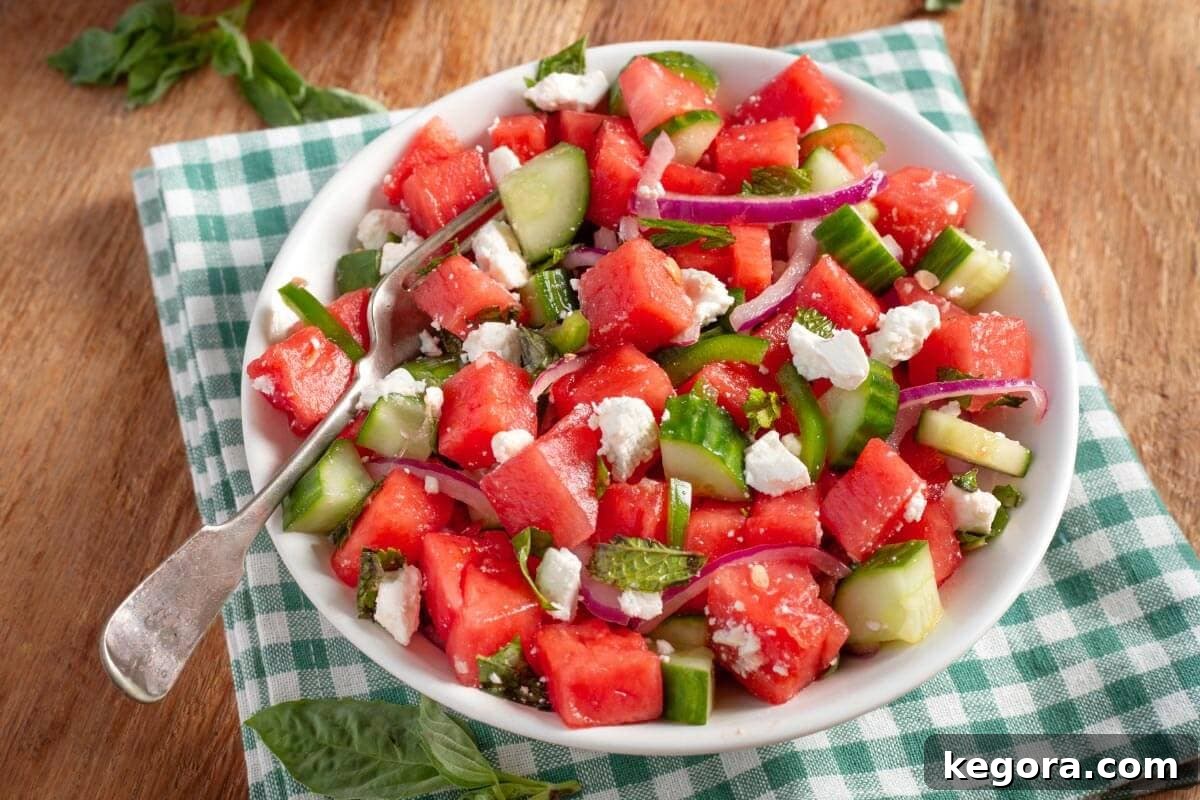 Watermelon Feta Salad in a white bowl on checkered napkin.