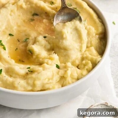 Mashed Potatoes and Gluten What You Need to Know 5 dairy-free potatoes in a serving bowl with a spoon