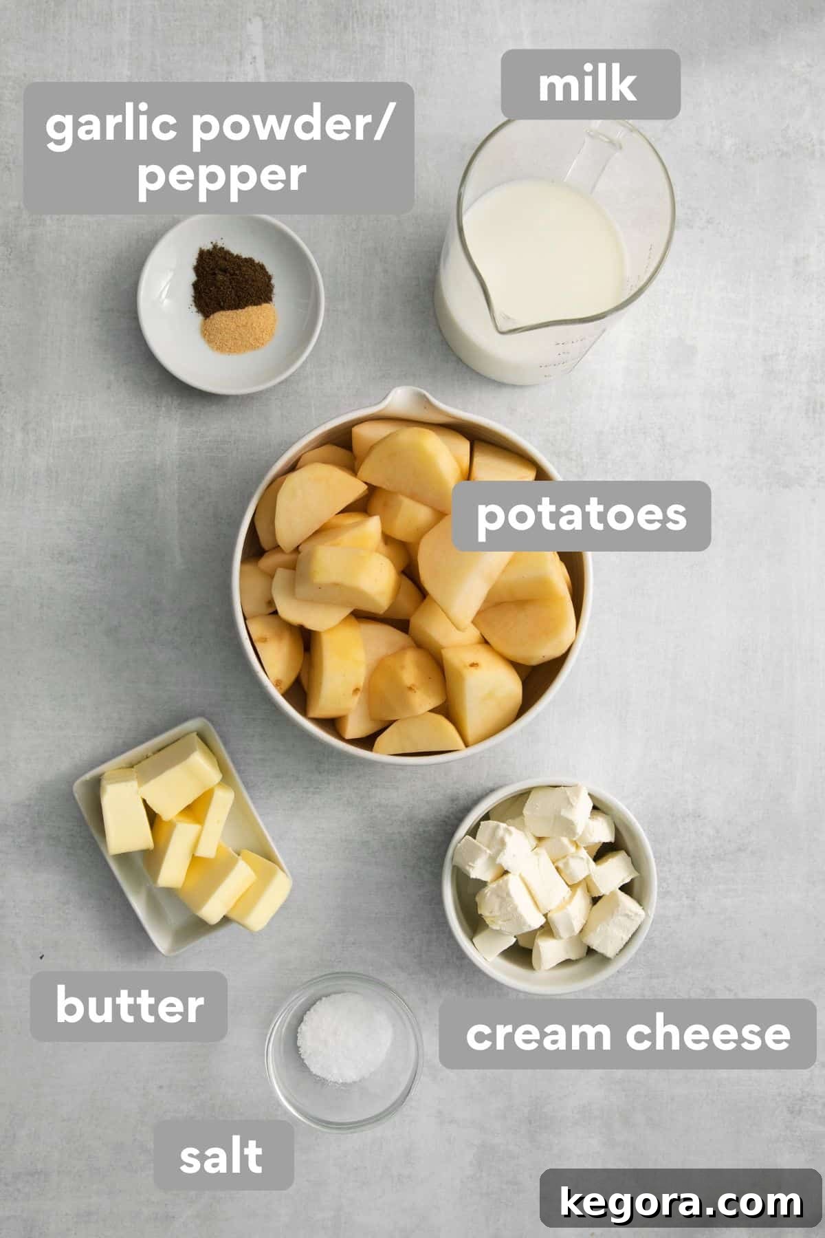 Creamy Gluten-Free Mashed Potatoes 3 Various mashed potato ingredients, including potatoes, butter, milk, cream cheese, and spices, neatly arranged on a kitchen countertop.