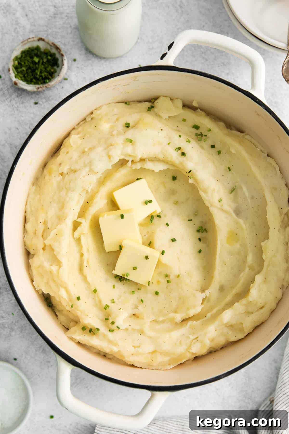 Creamy Gluten-Free Mashed Potatoes 7 A tantalizing close-up view of freshly made gluten-free mashed potatoes in a rustic pot, highlighting their creamy texture and inviting warmth.
