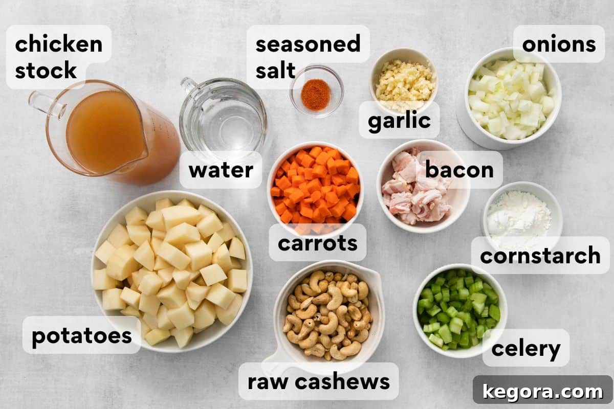 Plant-Based Creamy Potato Soup 4 Dairy-free potato soup ingredients laid out, including raw cashews, seasoned salt, potatoes, chicken stock, and bacon.