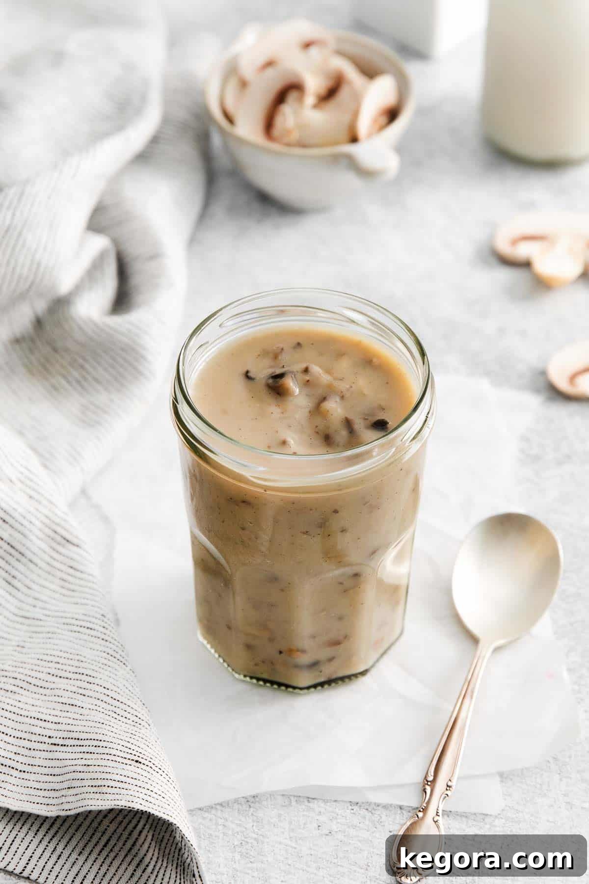 Velvety Gluten-Free Mushroom Magic 7 A beautifully presented cup of homemade gluten-free cream of mushroom soup, garnished with fresh herbs.