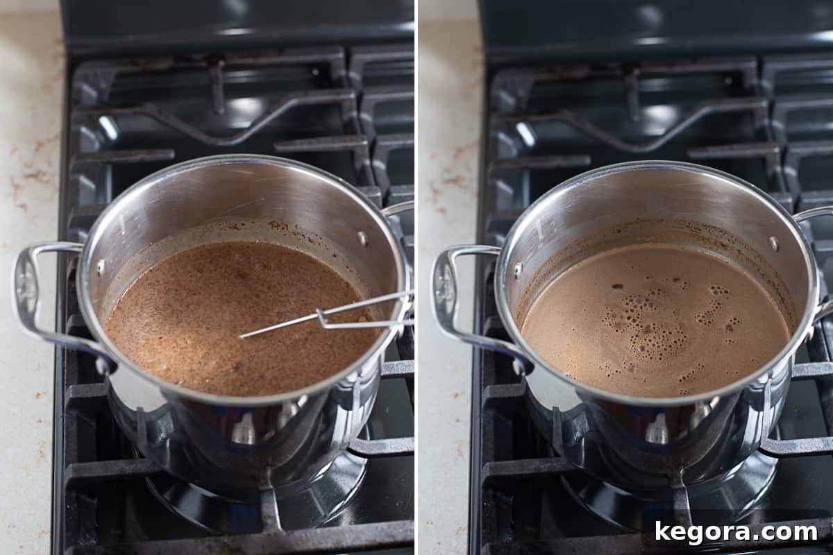 Dairy-Free Hot Chocolate A saucepan on a stovetop with dairy-free hot chocolate being stirred with a whisk, indicating the preparation process.