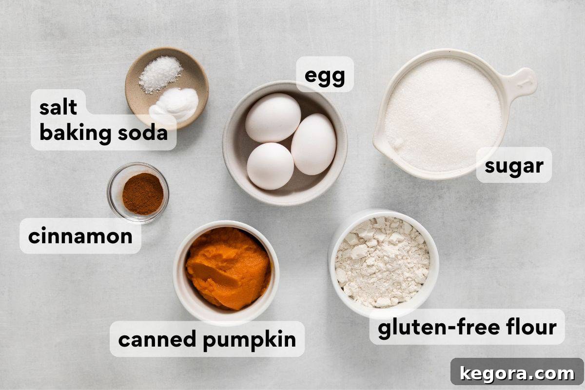 Şahane Glütensiz Balkabağı Rulosu (Sütsüz Yapılabilir) 4 All dry and wet ingredients for the gluten-free pumpkin roll cake are meticulously measured and neatly labeled in bowls, ready for mixing.