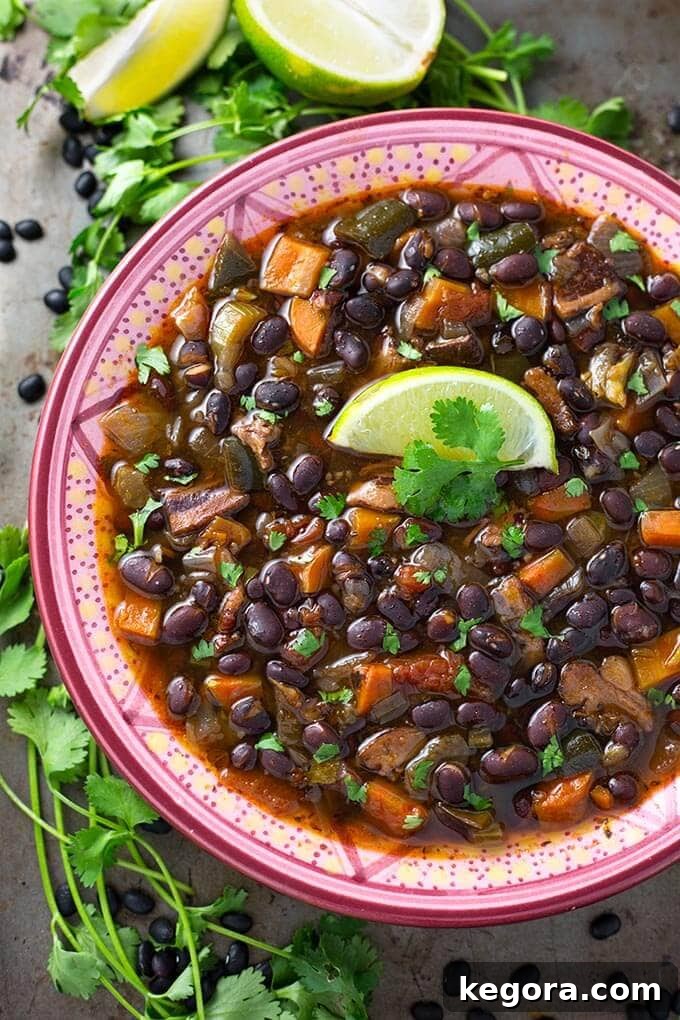 Black Bean Soup in a colorful bowl, garnished with cilantro and sour cream
