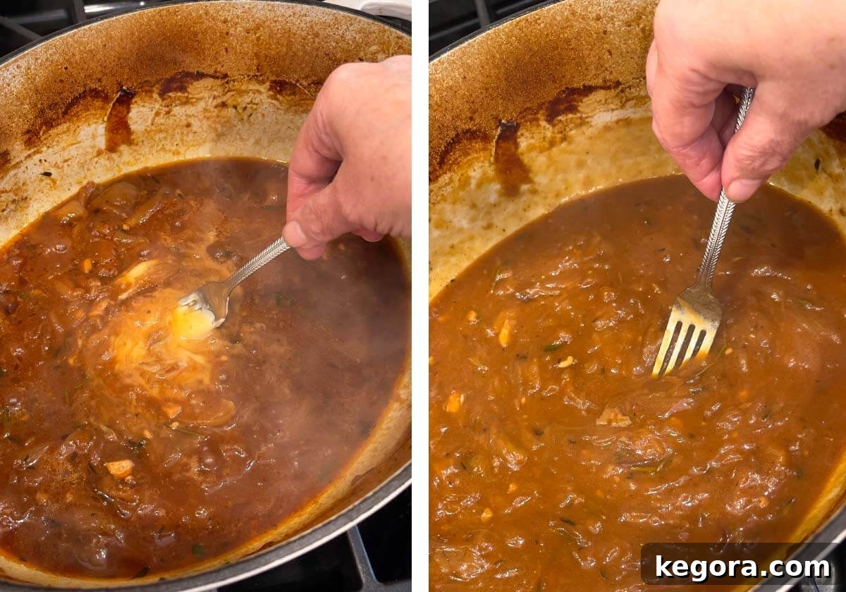 The butter-flour mixture being whisked into the simmering gravy in the Dutch oven, ensuring a smooth, lump-free consistency.