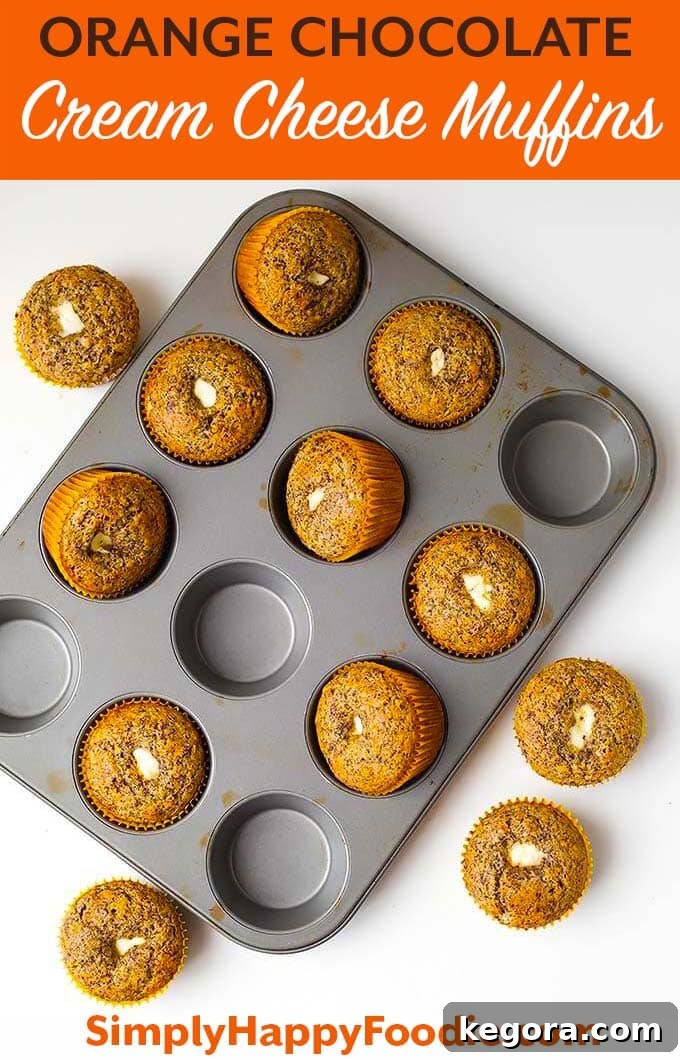 Zesty Chocolate Cheesecake Muffins 8 Orange Chocolate Cream Cheese Muffins are a delightful breakfast muffin, perfect for any morning. This nice chocolate orange muffin with a creamy center is wonderful to have with tea or coffee, making a memorable treat. Find the full recipe at simplyhappyfoodie.com #muffins #orangechocolatemuffins #muffinswithcreamcheese #breakfastmuffins #brunchideas #homemadebaking