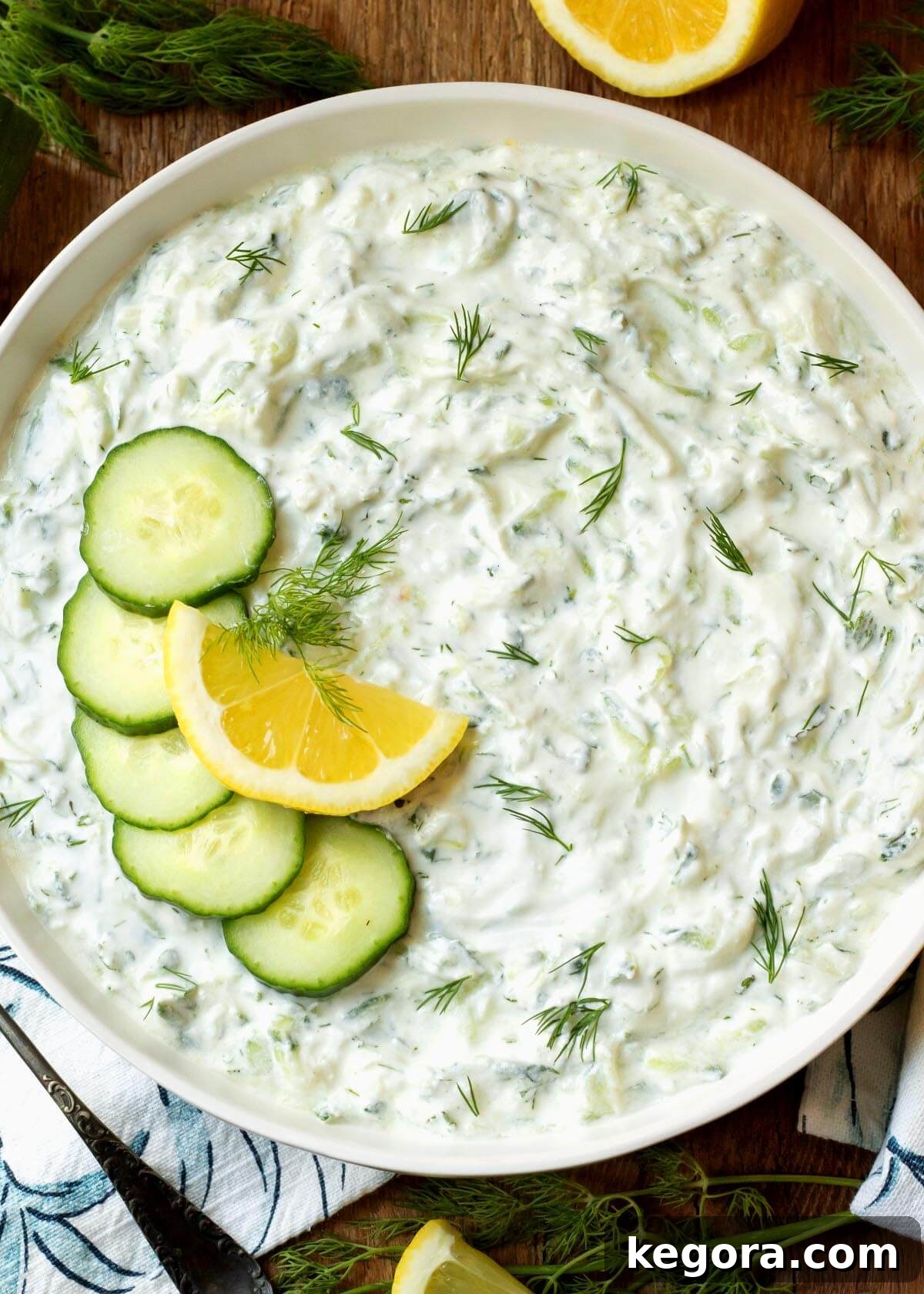 Refreshing Cucumber Yogurt Dip 2 Tzatziki Sauce in a bowl with garnishes, showcasing its creamy texture and fresh herbs.