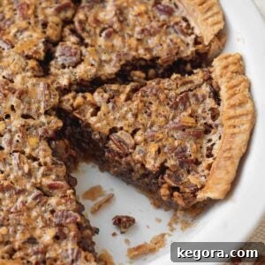 The Ultimate Gluten-Free Pie Collection 7 A close-up of a perfectly baked gluten-free pecan pie in a white serving dish, revealing its rich, nutty filling.