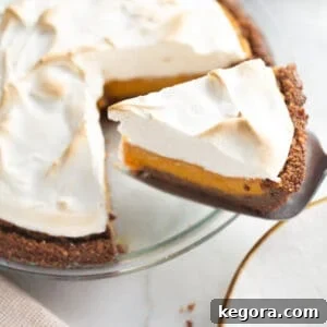 The Ultimate Gluten-Free Pie Collection 8 A luscious slice of gluten-free sweet potato pie being served, topped with a golden-brown marshmallow meringue.