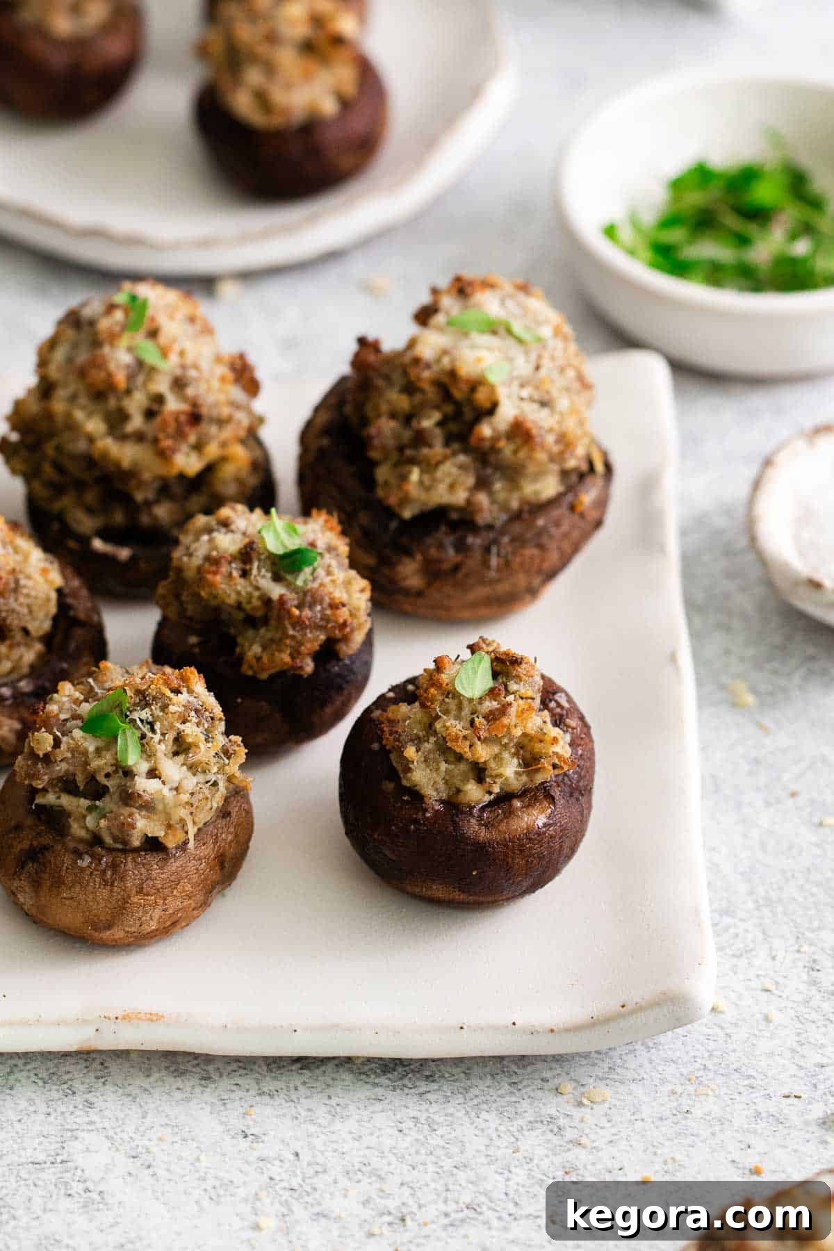 A close-up of beautifully baked gluten-free stuffed mushrooms on a platter, ready to be served.