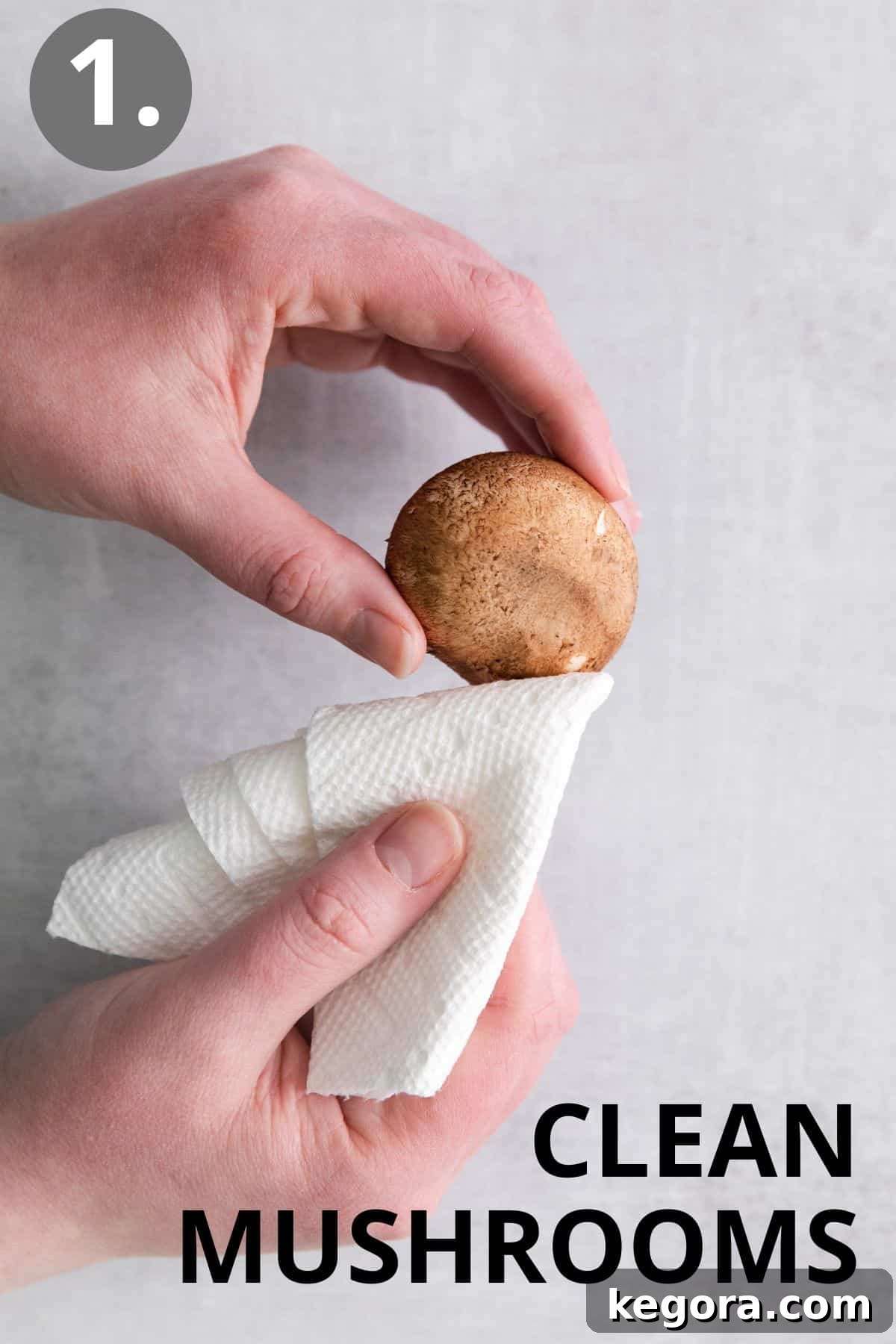 A person meticulously cleaning mushrooms with a dry cloth on a cutting board.