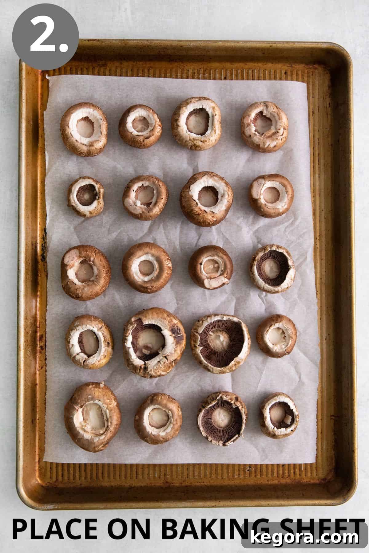 Cleaned mushroom caps arranged neatly, hole-side up, on a baking sheet.