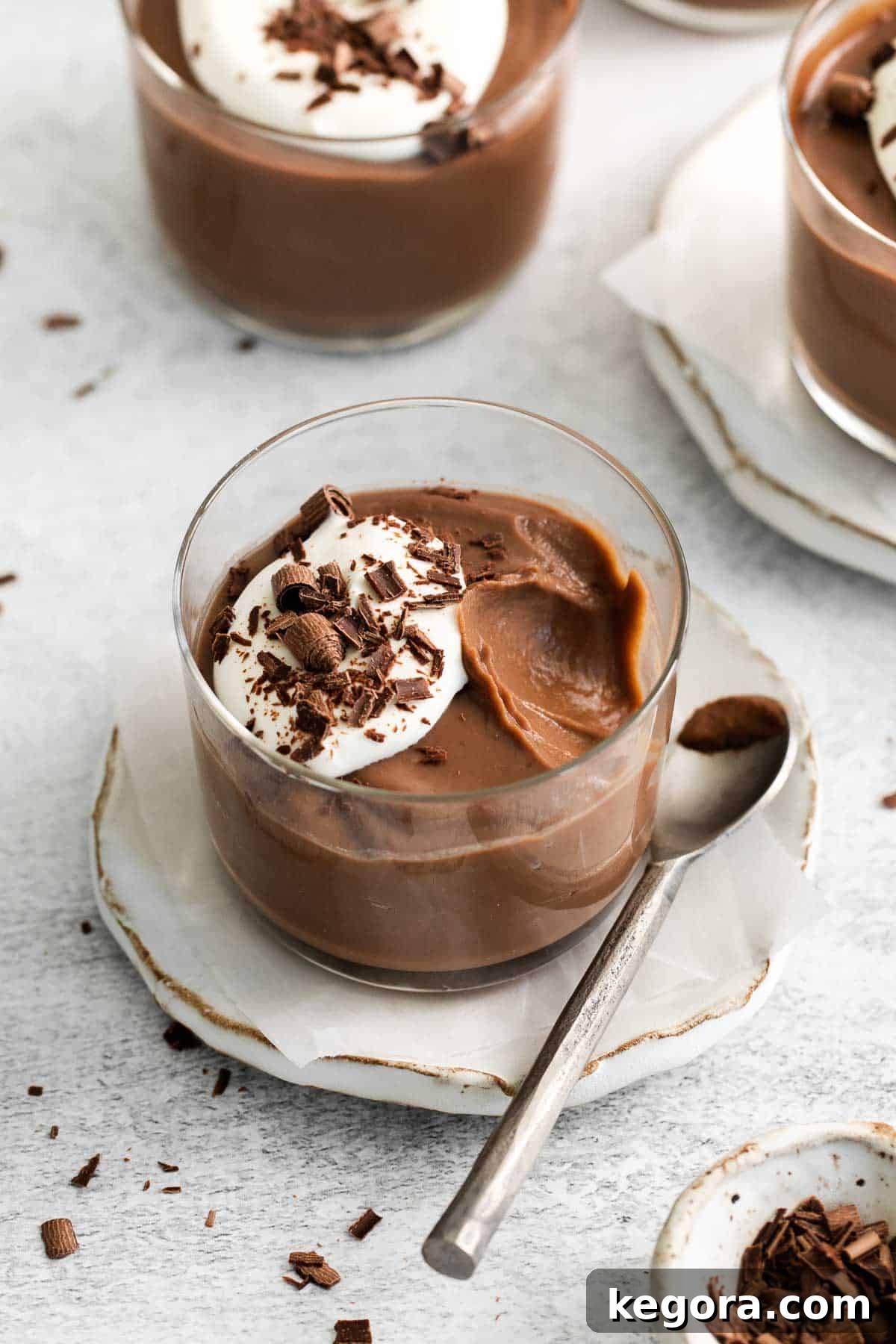 Decadent Gluten-Free Chocolate Pudding 8 A close-up view of a glass ramekin perfectly filled with rich, glossy gluten-free chocolate pudding, showcasing its smooth texture.