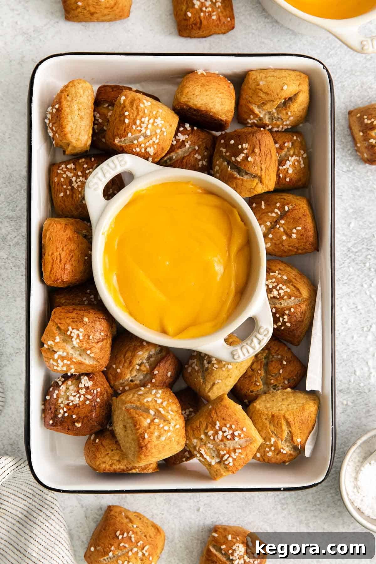 Pretzels in a serving dish with creamy gluten-free cheese sauce in the middle