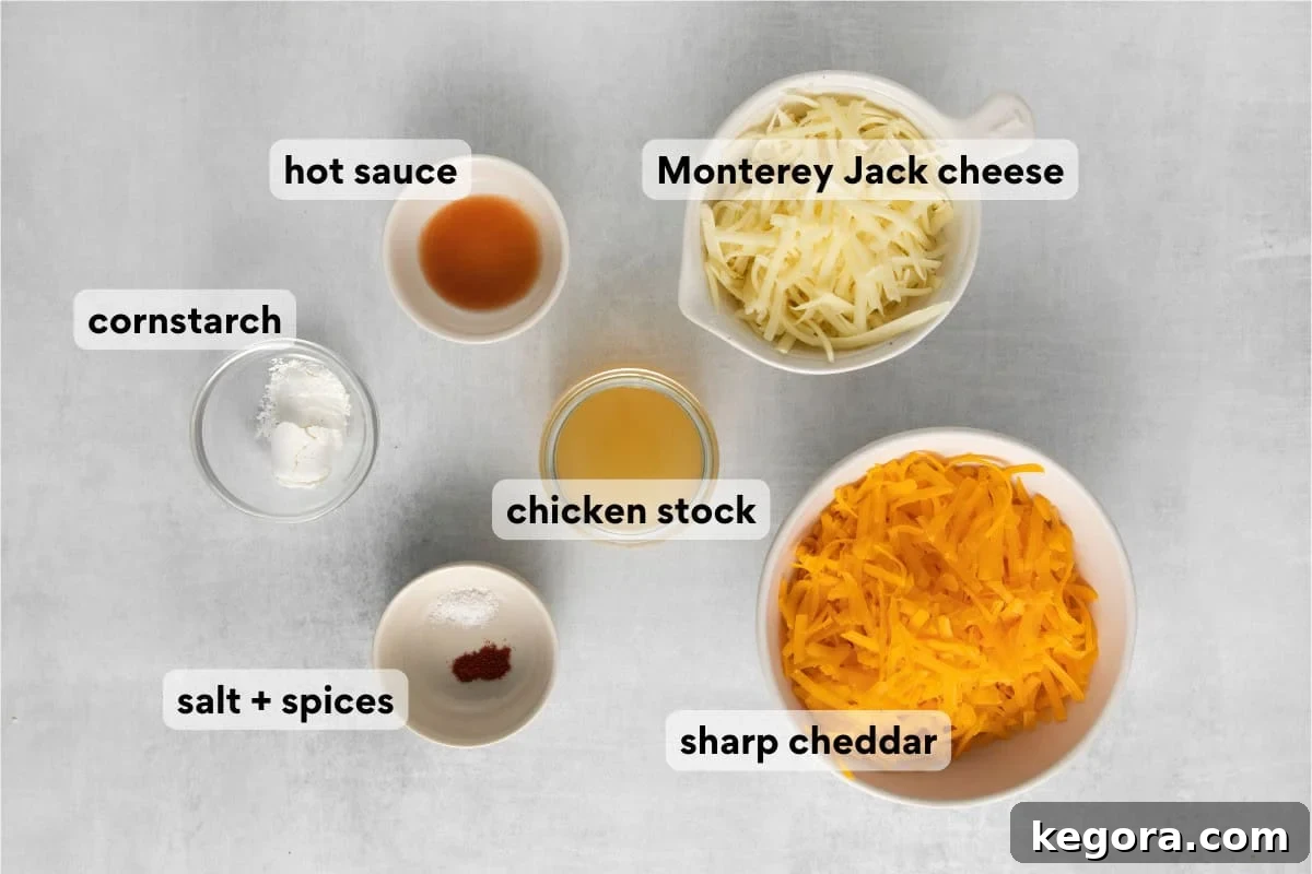 Gluten-free cheese sauce ingredients laid out on a countertop, including blocks of cheese, hot sauce, and spices.
