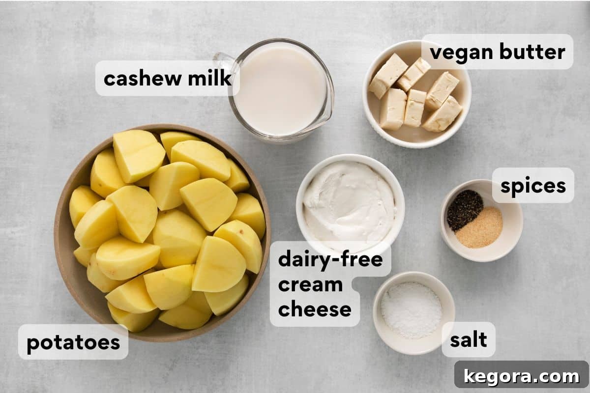 Velvety Dairy-Free Mashed Potatoes 4 Dairy-free mashed potato ingredients measured and labeled, including potatoes, vegan butter, cashew milk, and cream cheese.