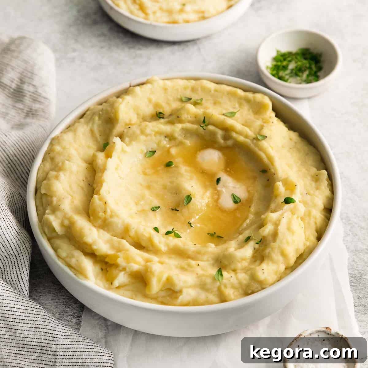 Velvety Dairy-Free Mashed Potatoes 9 Delicious dairy-free potatoes in a serving bowl with a spoon scooping into the bowl, ready to be served.