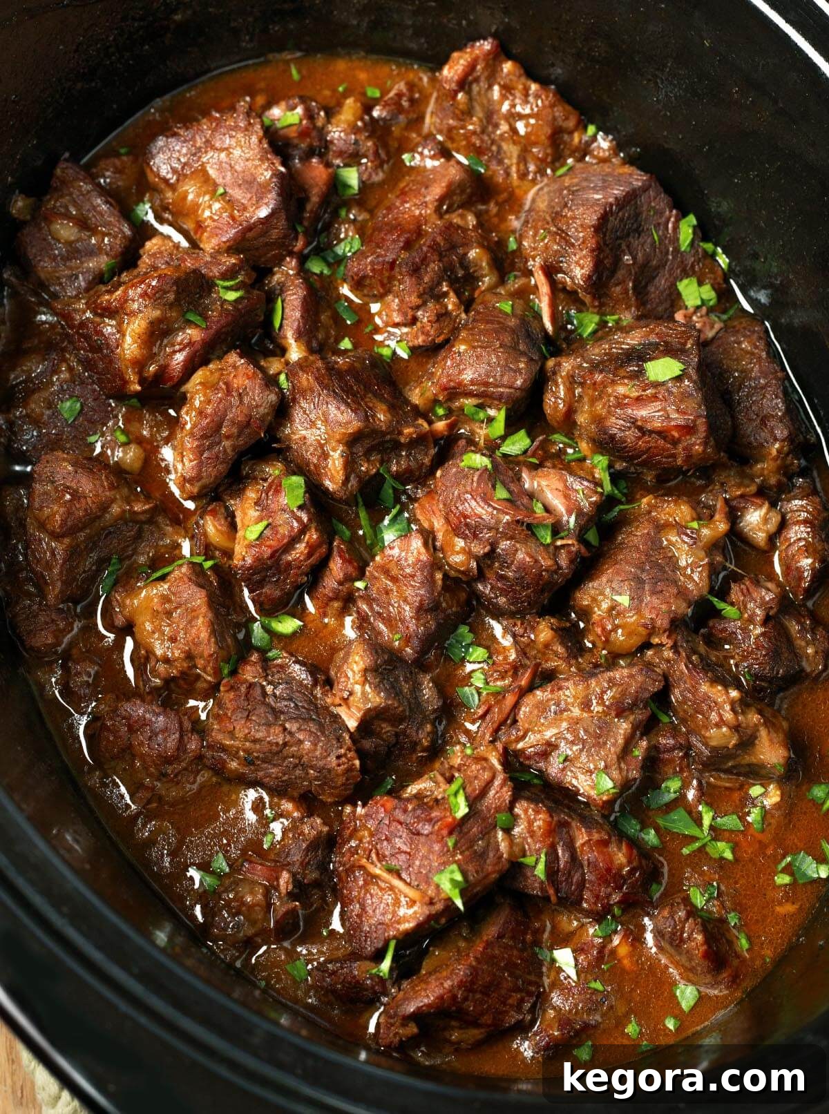 Melt-in-Your-Mouth Slow Cooker Garlic Butter Steak Bites 13 Slow Cooker Garlic Butter Steak Bites in black crock