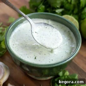 Cilantro Cream Sauce in a green bowl with a spoon