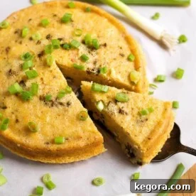 Creamy Southwest Instant Pot Corn 6 Cut Slice of Southwest Corn Pudding garnished with green onion being lifted from rest of pudding