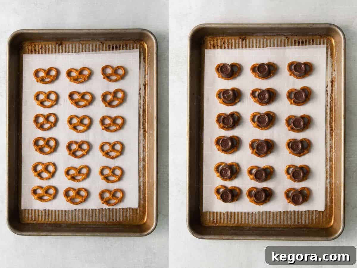 A baking sheet with rows of pretzels, some topped with Rolos, ready for baking.
