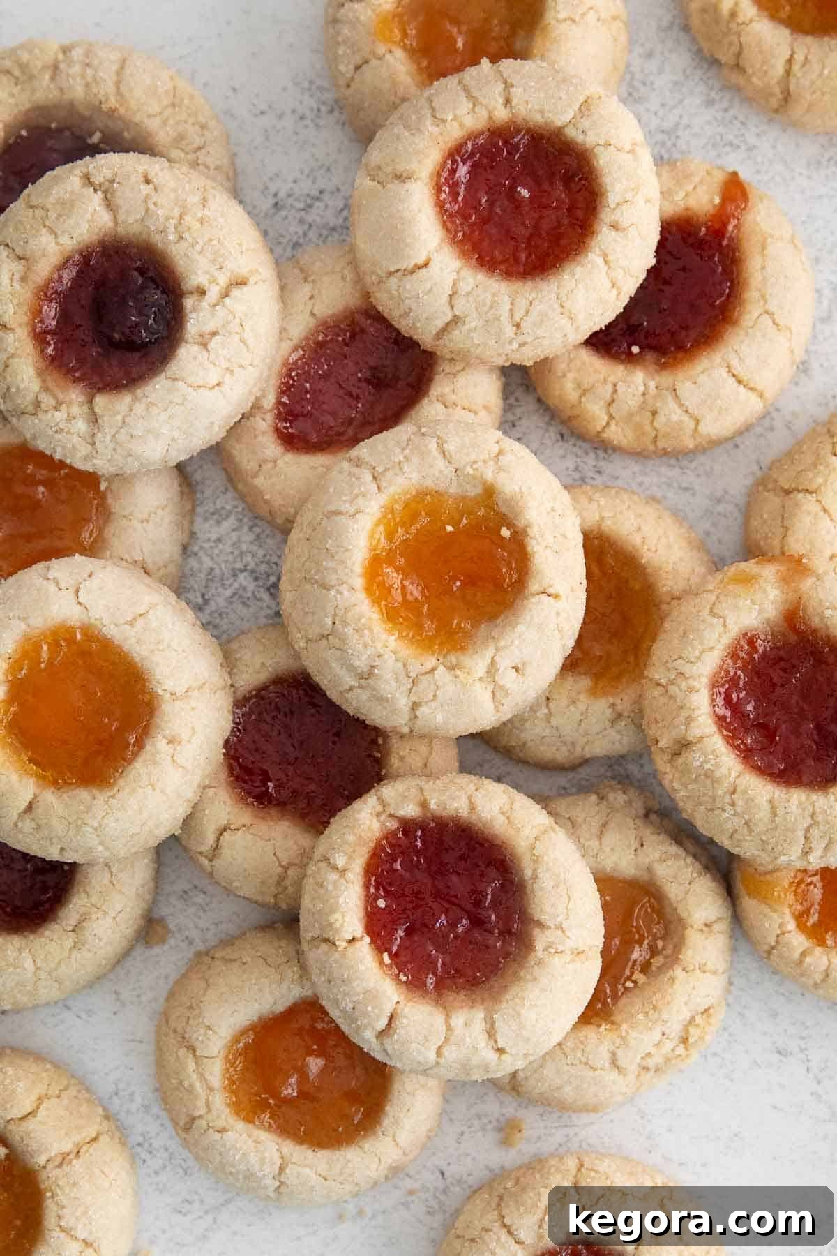 Gluten-Free Thumbprint Delights 8 A delectable spread of jam-filled gluten-free thumbprint cookies artfully arranged on a kitchen countertop.