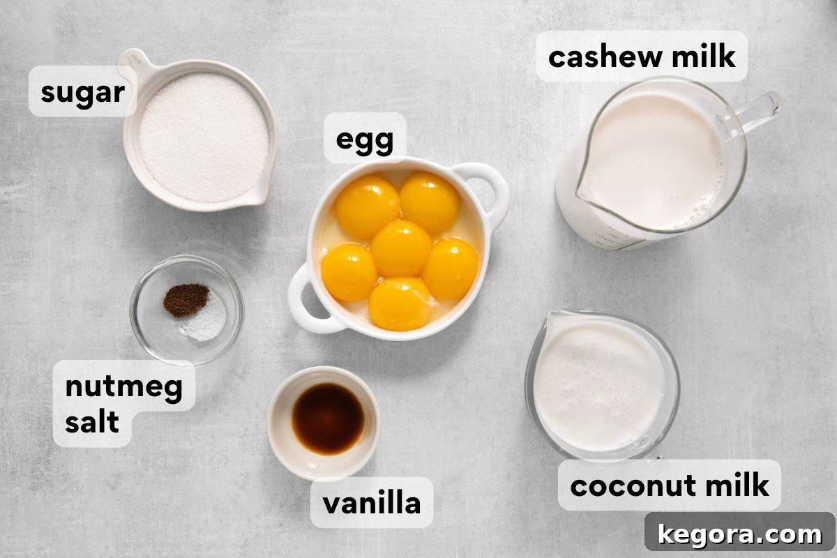 Spiced Dairy-Free Nog Delight 4 A selection of dairy-free eggnog ingredients, including cashew milk, canned coconut milk, egg yolks, granulated sugar, kosher salt, vanilla extract, and ground nutmeg, all measured and clearly labeled for preparation.
