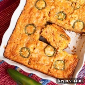 Loaded Tex-Mex Cornbread 11 Tex-Mex Cornbread in a pan, sliced, with one slice on its side