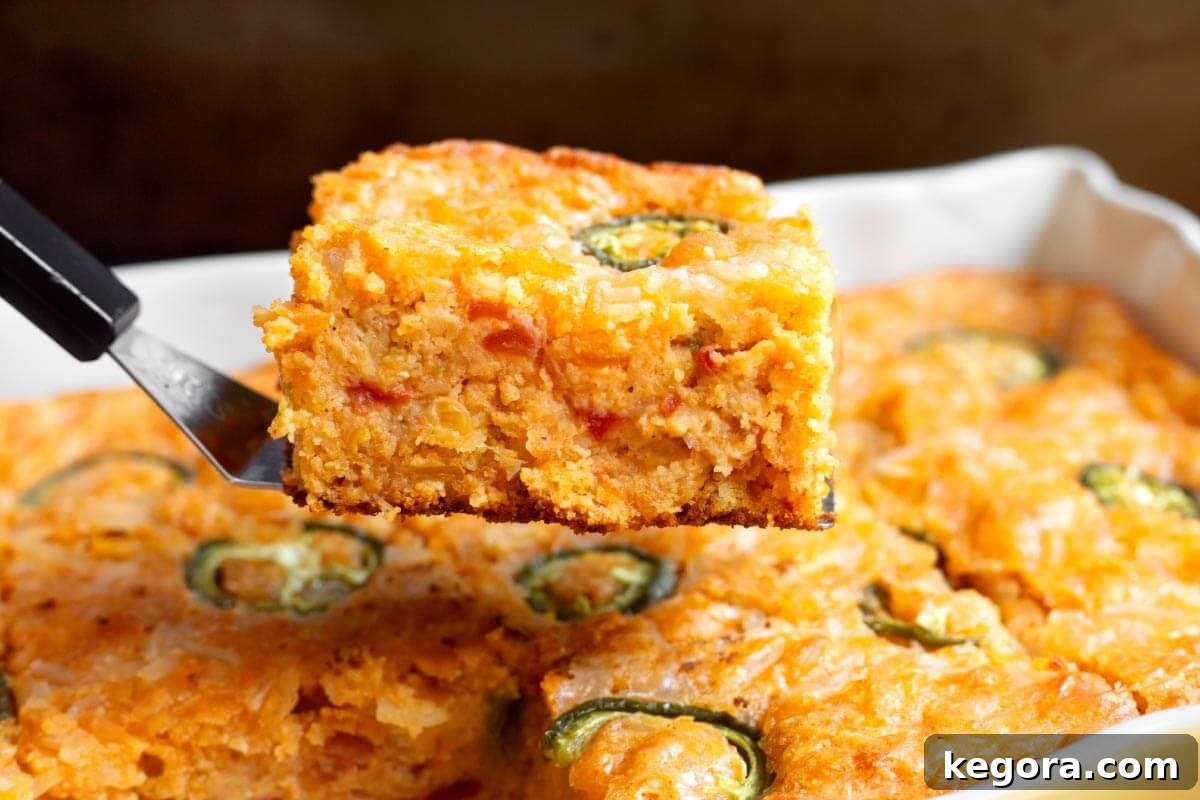 Loaded Tex-Mex Cornbread 3 Slice of Tex-Mex Cornbread on a spatula from the side.