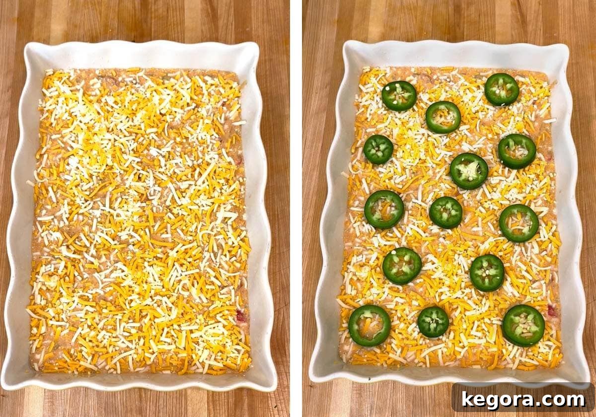 Loaded Tex-Mex Cornbread 9 cornbread batter in baking dish with cheese on top, with jalapeños on top.