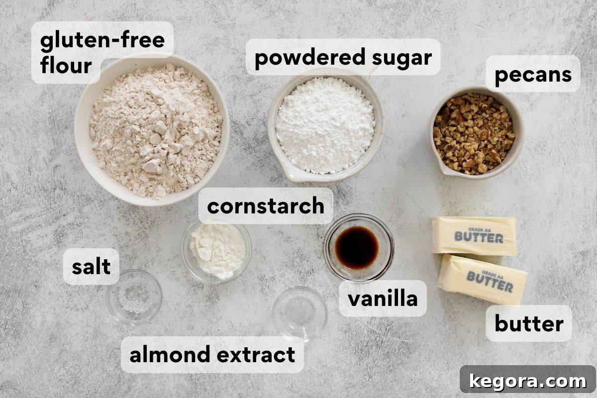 Dusted Dream Gluten-Free Snowballs 4 A carefully arranged display of all the measured ingredients for gluten-free snowball cookies, including butter, powdered sugar, flour, nuts, and extracts, ready for mixing.