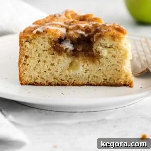 A close up photo of a slice of apple cake on a plate