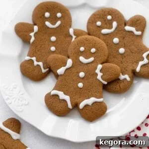 gluten free gingerbread cookies on white plate with glass of milk