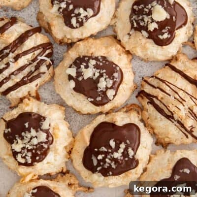 chocolate coconut cloud cookies topped with chocolate drizzle and macadamia nuts.