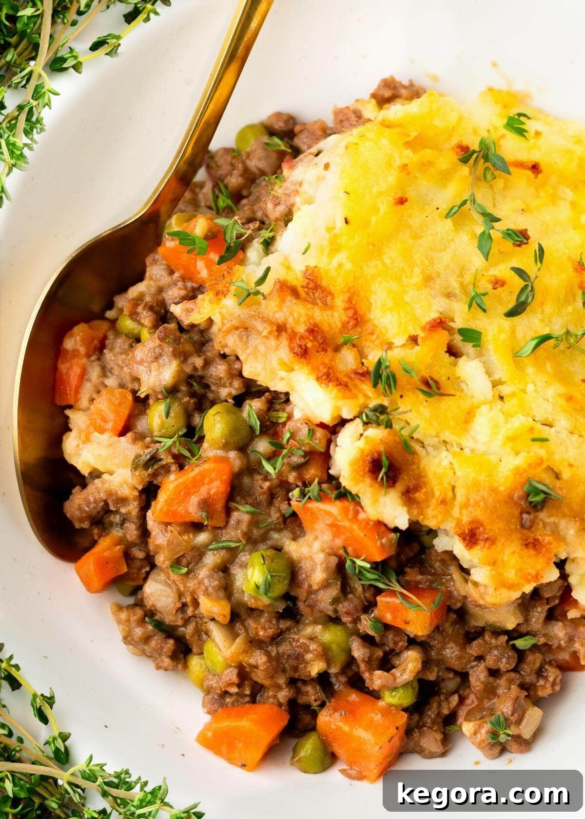 Classic Irish Cottage Pie served in a white bowl with a spoon, ready to be enjoyed.