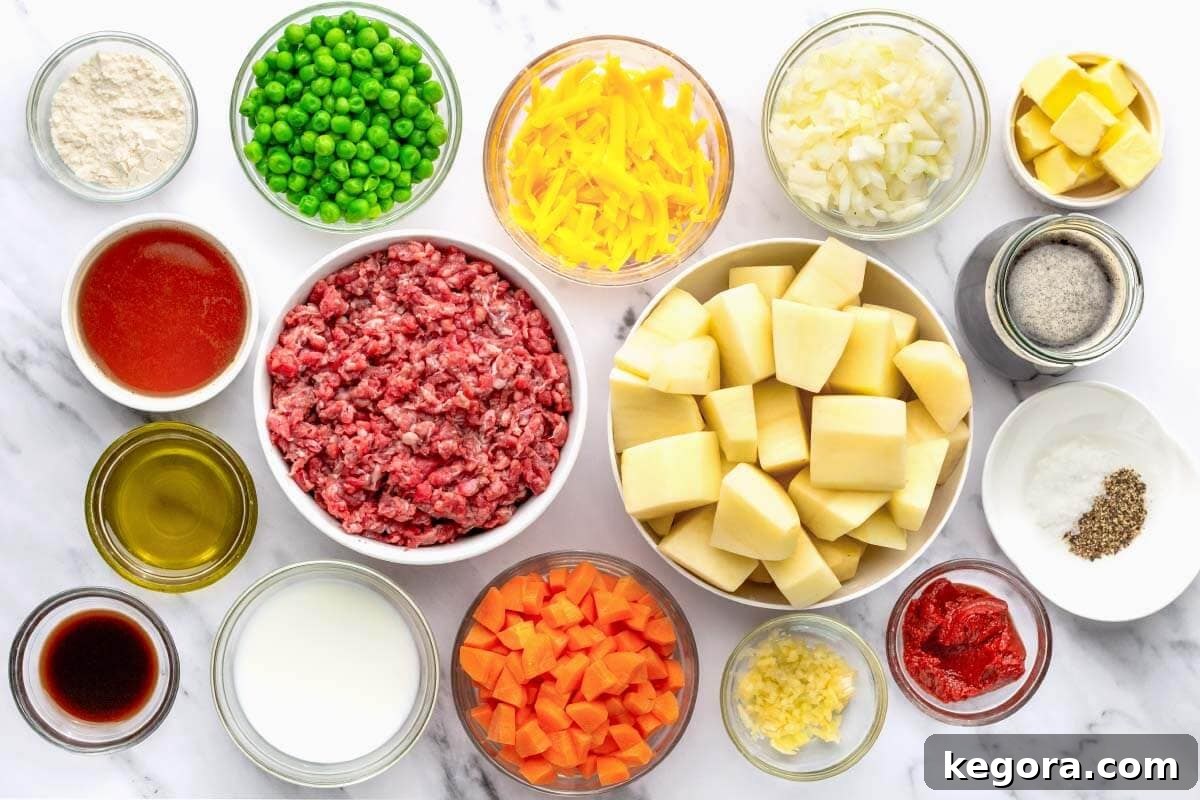 Ingredients for Irish Cottage Pie laid out on a wooden surface, including potatoes, beef, vegetables, and Guinness.