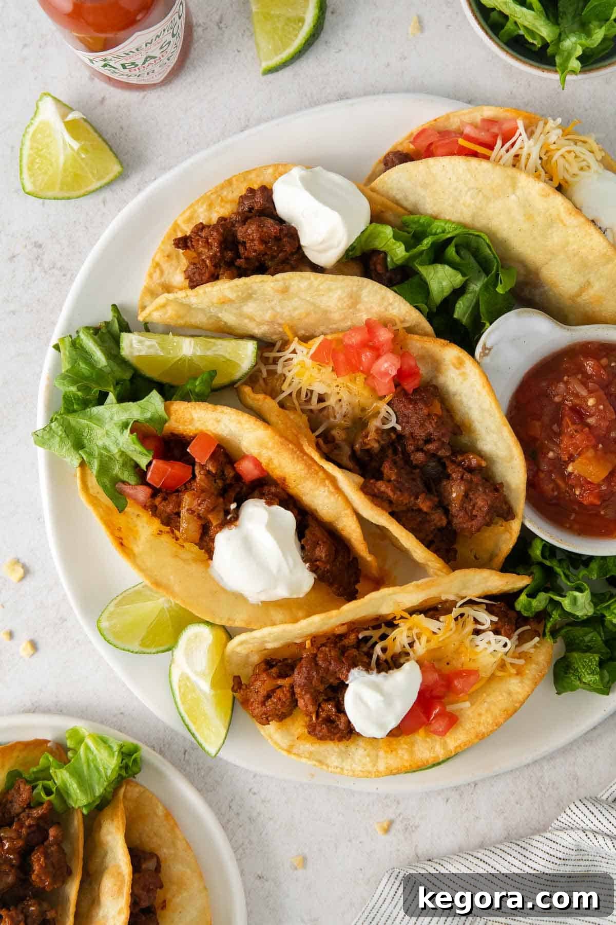 Effortless Gluten-Free Taco Night 3 Plated gluten-free tacos with a variety of fresh toppings including salsa and cilantro.