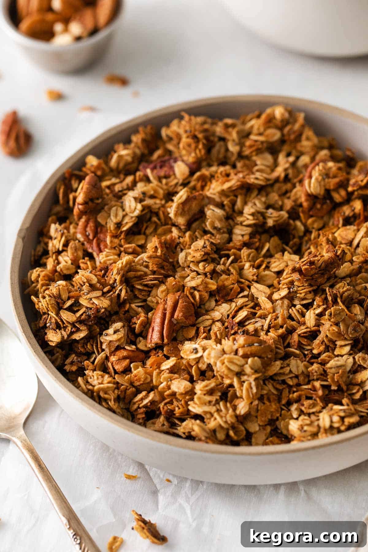 A close-up shot of a bowl filled with homemade Gluten-free granola, highlighting its rich texture and golden brown clusters.