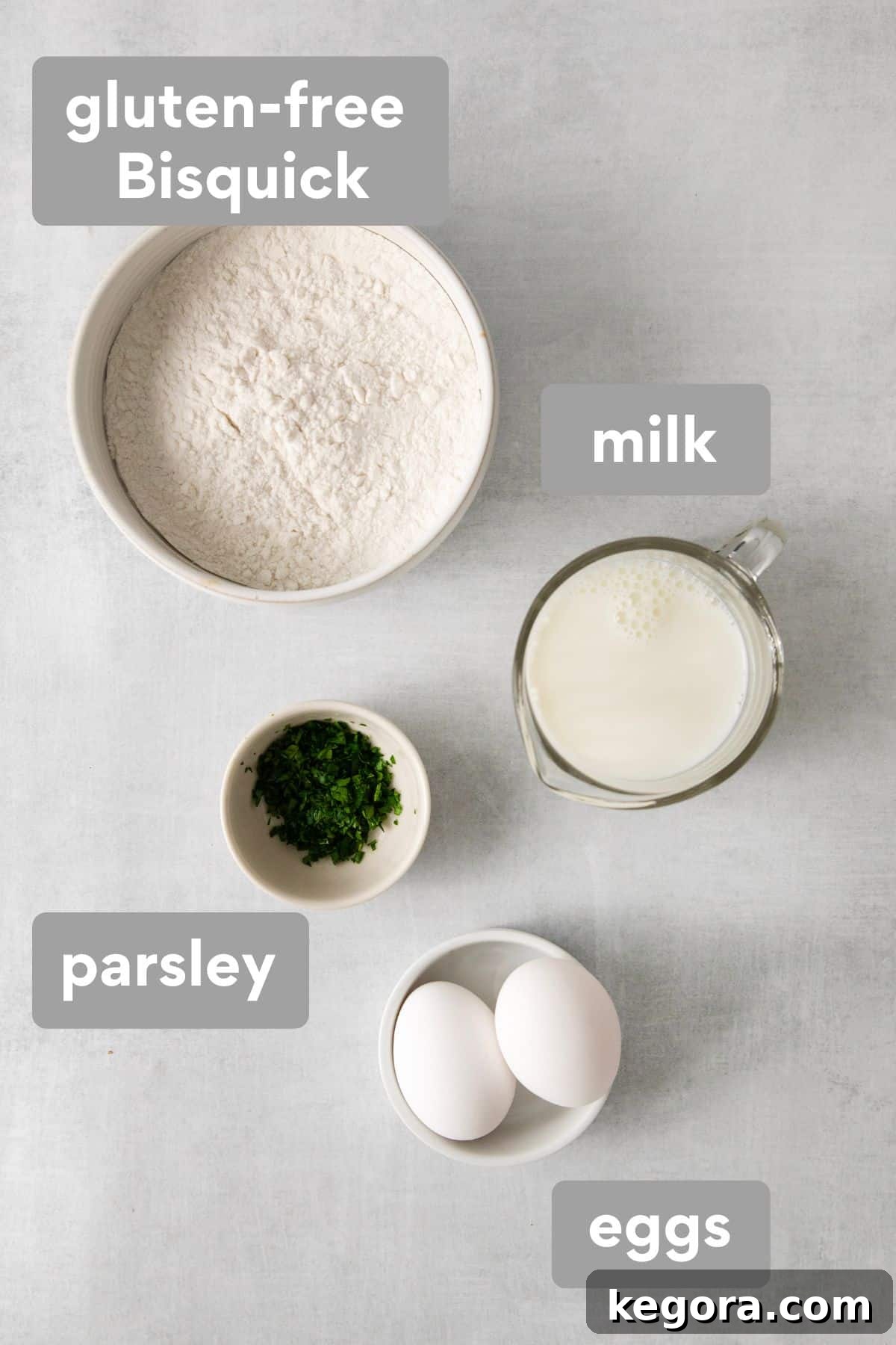 Dumpling ingredients on a counter top, including Bisquick mix, milk, eggs, and parsley