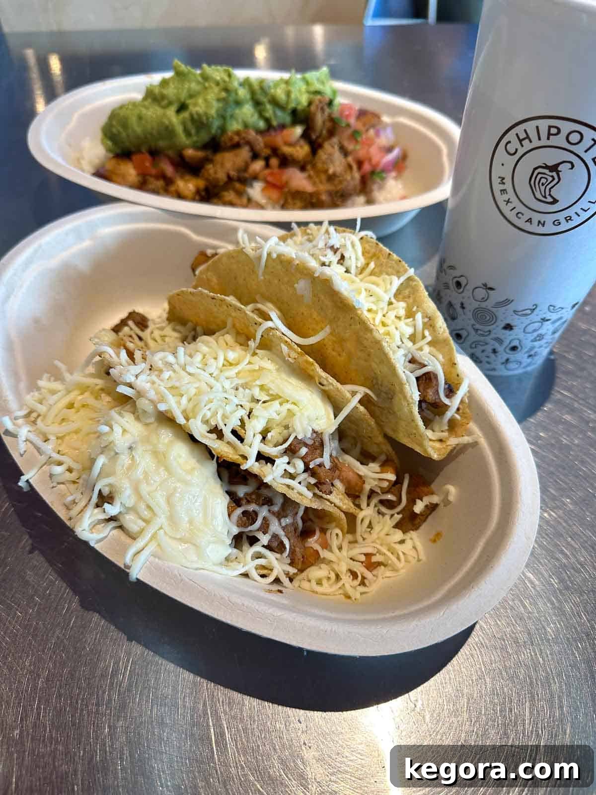 Crunchy tacos topped with queso and cheese at Chipotle.