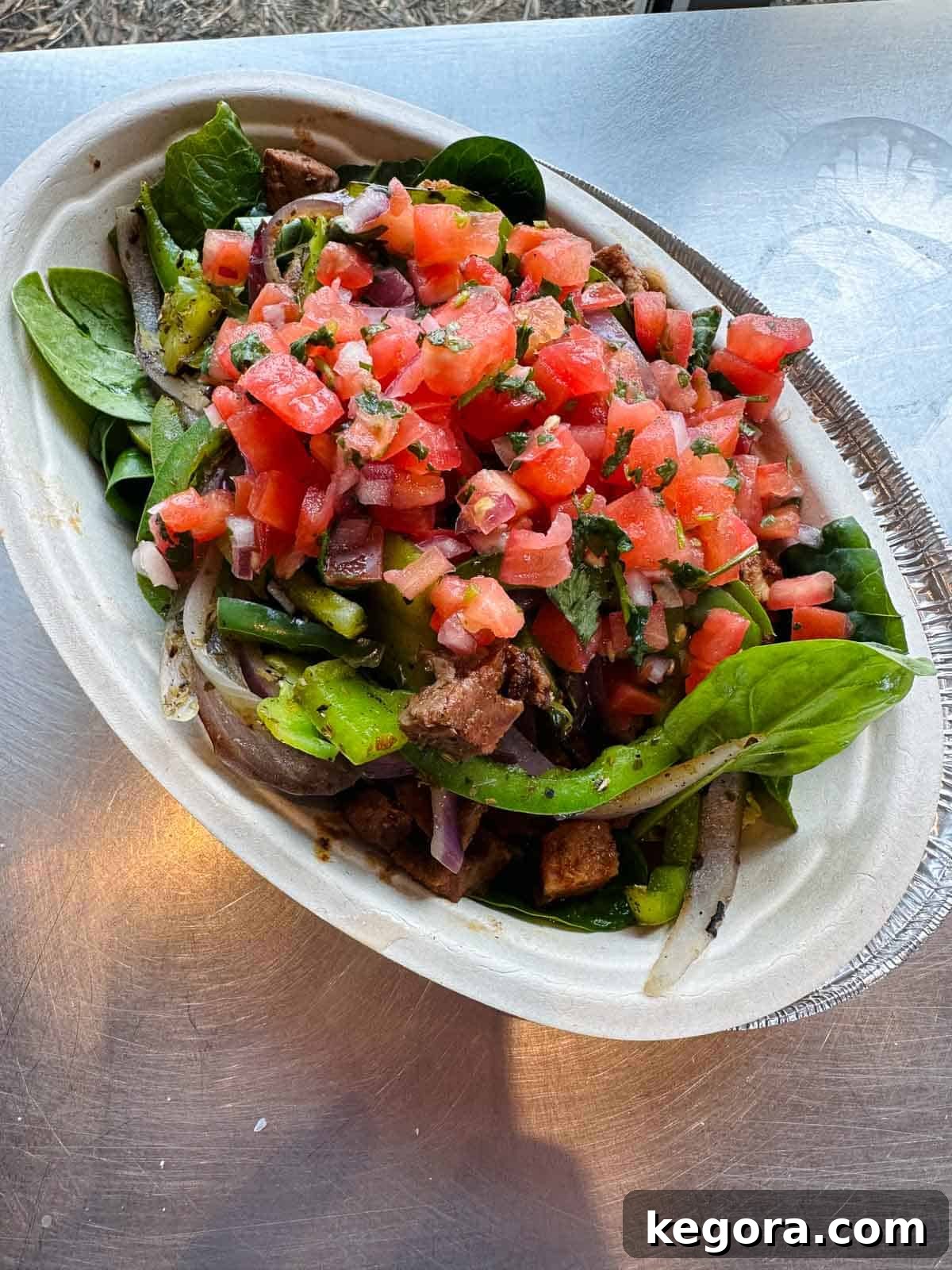 Chipotle salad with tomato salsa and steak.